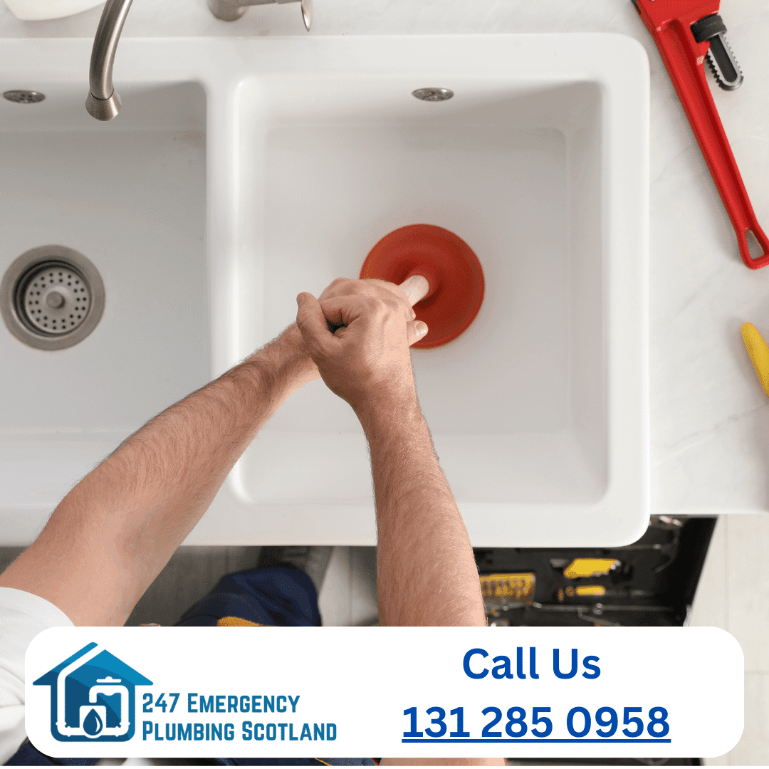 Clogged drain being cleared by plumber