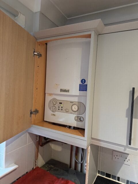 Vaillant boiler inside a kitchen cupboard